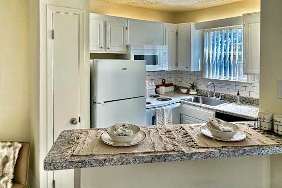 This is a photo of the kitchen of a 1245 square foot 2 bedroom apartment at Cambridge Court Apartments in Dallas, TX.