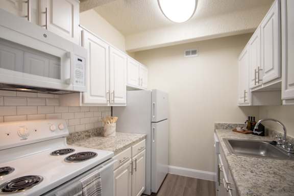 This is a photo of the kitchen of a 1245 square foot 2 bedroom apartment at Cambridge Court Apartments in Dallas, TX.