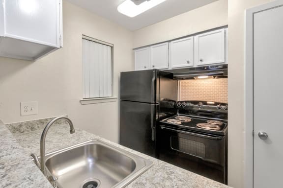 This is a photo of the kitchen of a 1245 square foot 2 bedroom apartment at Cambridge Court Apartments in Dallas, TX.