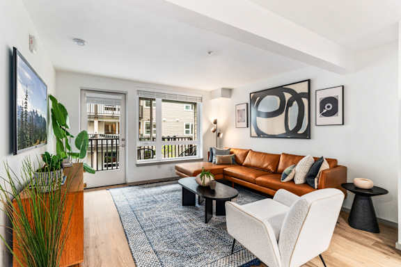 Living Room with Leather Couch at Solera Apartments, Washington, 98056
