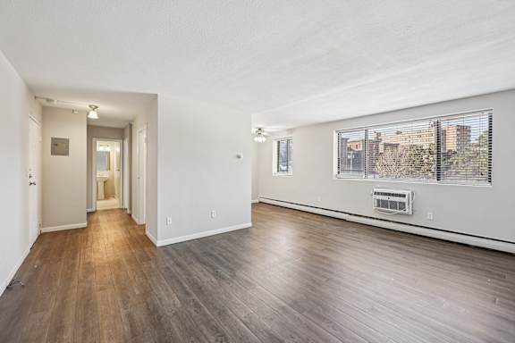 A room with wooden floors and white walls.