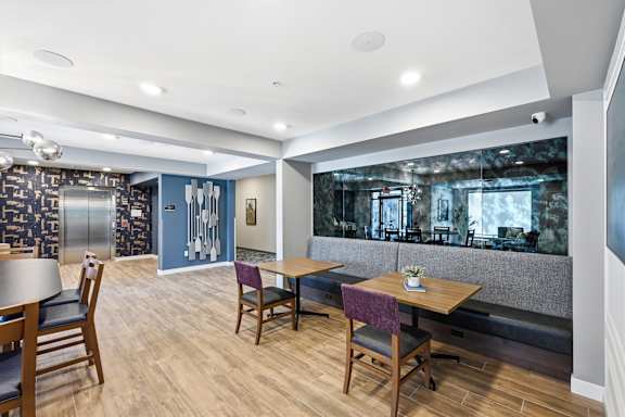 A dining area with wooden chairs and tables.