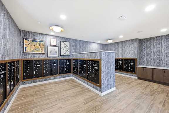 A room with a long counter and a wall of cabinets.