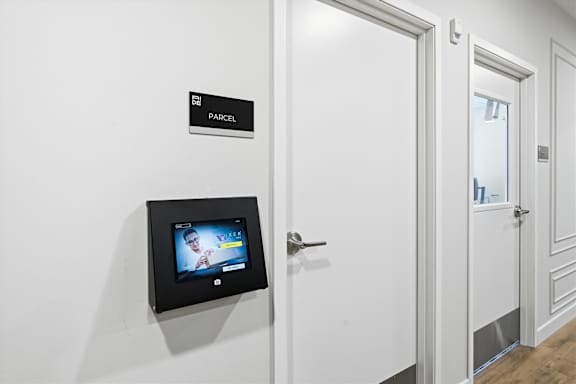 A parcel sign is on a white door.