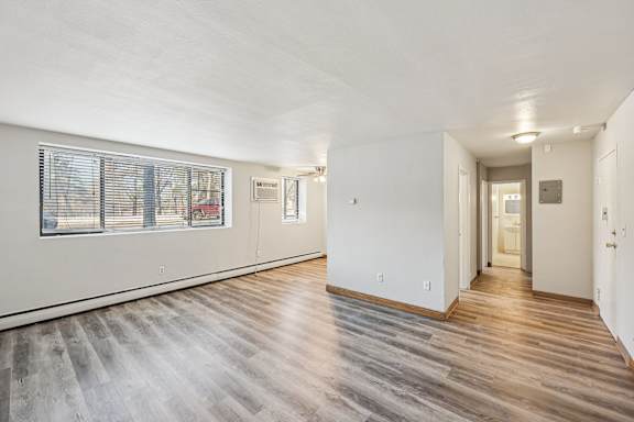 A room with wooden floors and white walls.