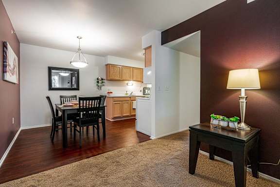 a living room with a dining room table and a kitchen
