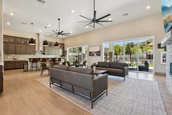 A Living Room with Ceiling fan at Montessa Apartments, California