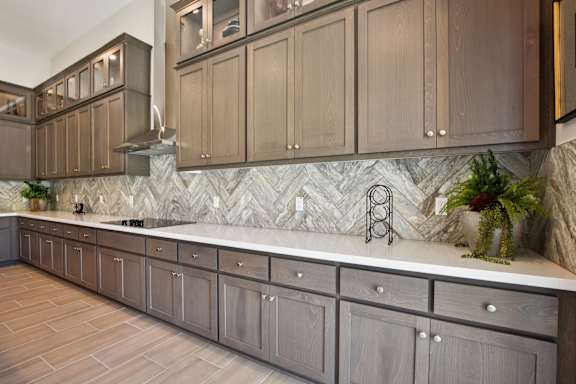 A Kitchen with Brown Cabinets at Montessa Apartments, Vacaville