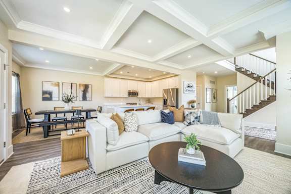 A living room with a black coffee table and a white couch.