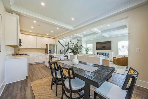A modern kitchen with a dining table set for four.
