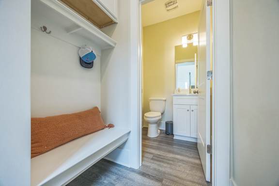 A small bathroom with a toilet and a mirror.