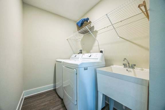 A small bathroom with a washer and dryer built into the cabinetry.