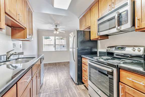 A kitchen with wooden cabinets and stainless steel appliances.