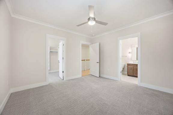 A room with a ceiling fan and carpeted floor.