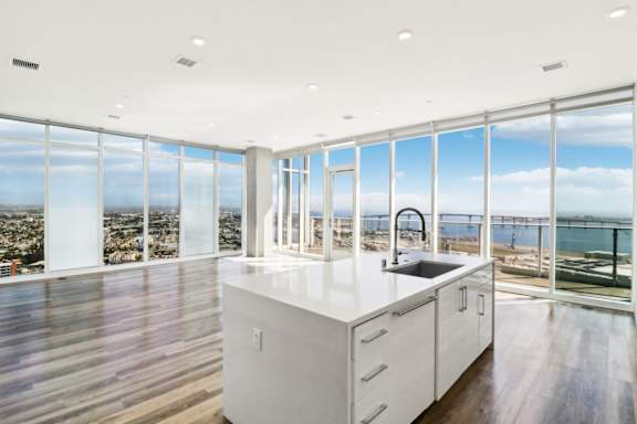 A modern kitchen with a view of the city and water.