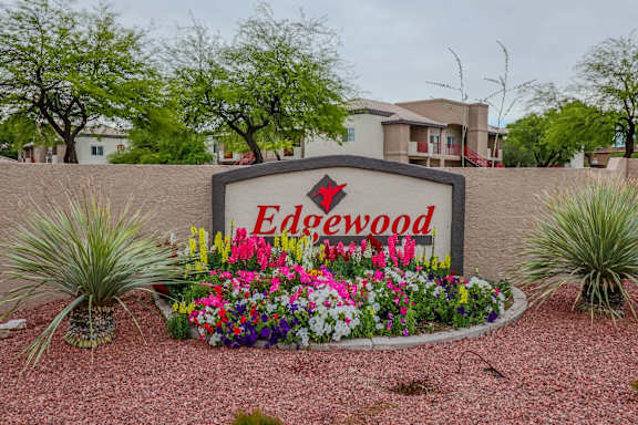 A sign that says Edgewood in front of some houses.