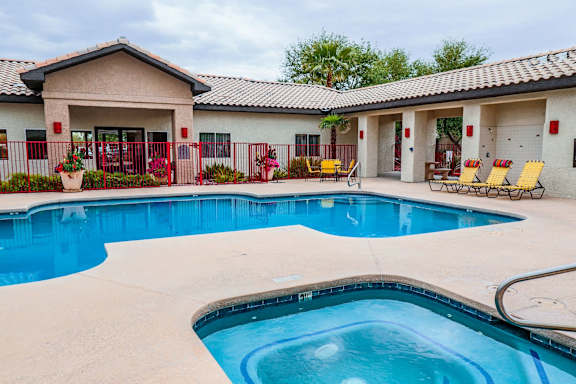 A pool with a building in the background.