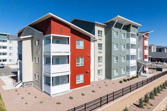 A row of modern townhouses with different colors.