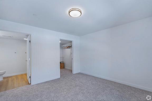 A room with a carpeted floor and a ceiling light.