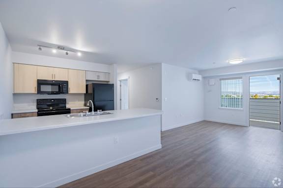 A kitchen with a microwave and oven built into the cabinetry.