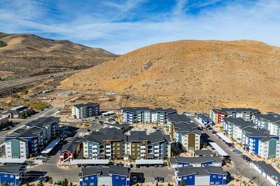 A large housing complex with many buildings in a desert landscape.