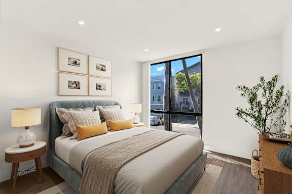 A bedroom with a large bed and a view of the outside. at Bonnie Brae Apartments, California
