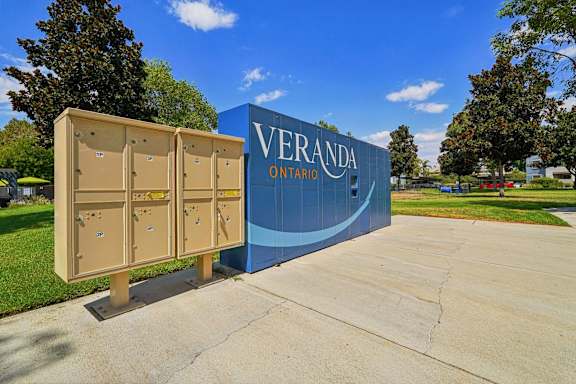 A sign that says Veranda Ontario stands in front of a row of portable toilets.