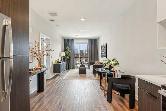 A modern kitchen with dark wood floors and a large island.