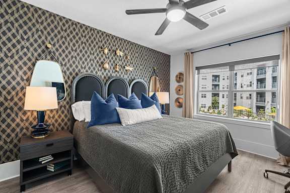 a bedroom with a bed and a ceiling fan