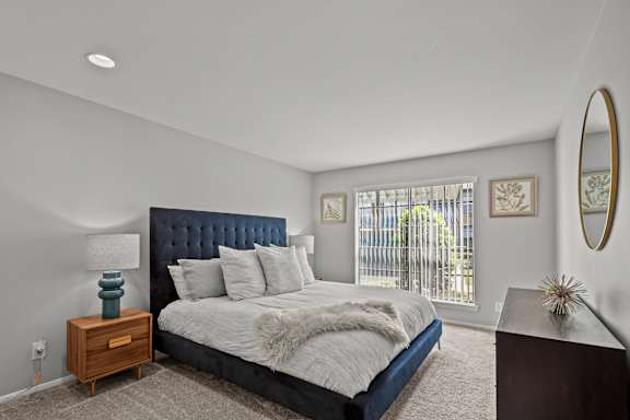 a bedroom with a large bed and a window