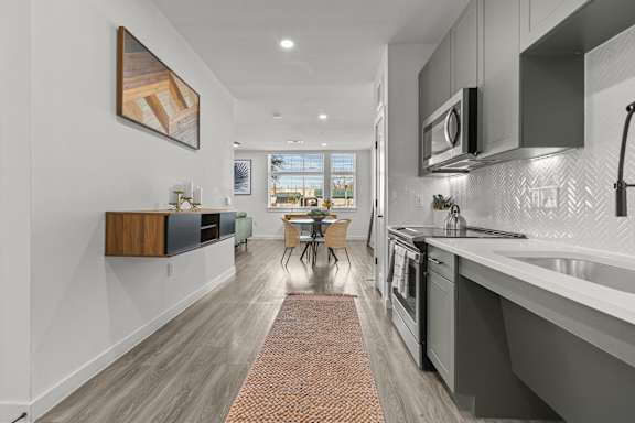 A modern kitchen with a dining table and chairs.