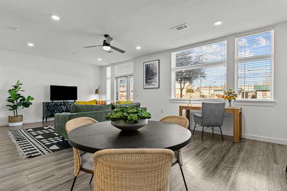 A modern dining room with a round table and chairs.