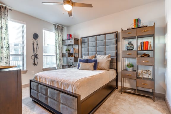 a bedroom with a bed and a bookshelf