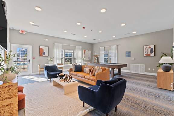 A spacious living room with a variety of furniture and decor.