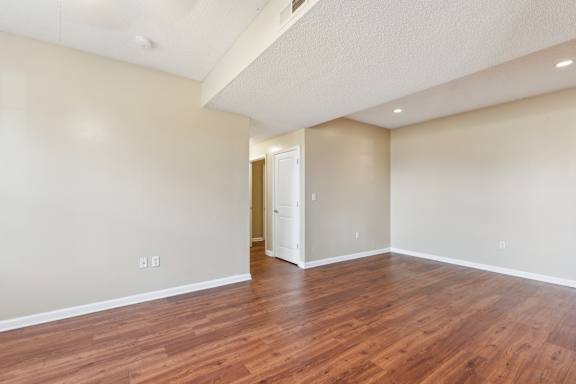 A room with wooden floors and a white door.