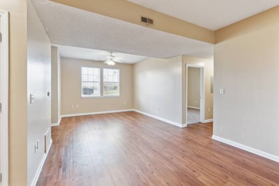 A room with wooden floors and a window.
