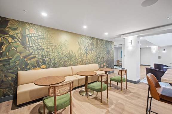 A room with a green and yellow wallpaper and a sofa.