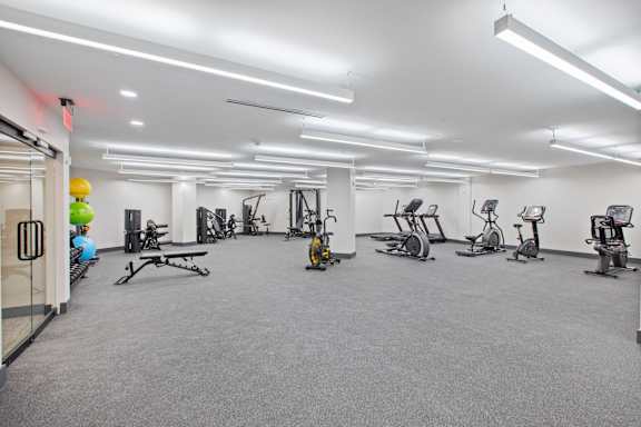 A gym with a variety of exercise equipment.