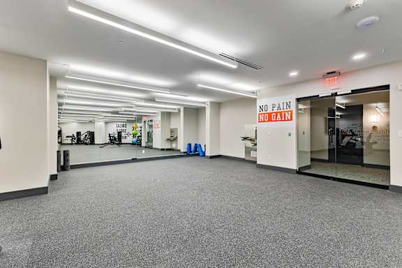 A gym with a sign that says "NO PAIN NO GAIN".