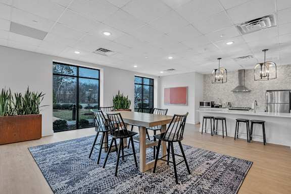A dining room with a table set for four.
