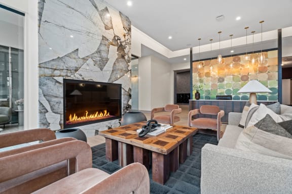 a living room with couches and chairs and a fireplace