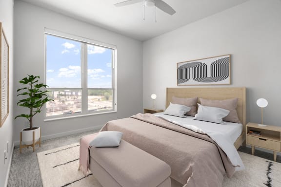 a bedroom with a bed and a large window