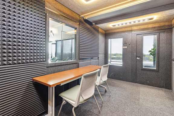 A conference room with a wooden table and two chairs.