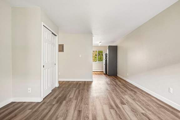 A room with a white door and a wooden floor.
