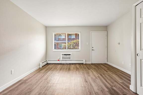 A room with a window and a door.
