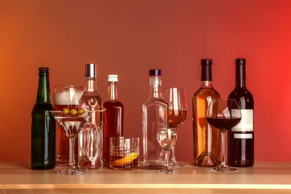 a variety of wine bottles and glasses on a table