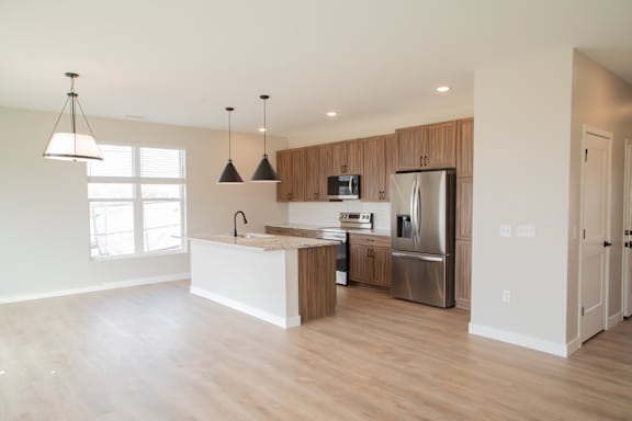 A kitchen with wooden cabinets and stainless steel appliances.
