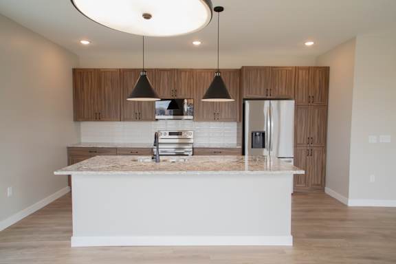 A kitchen with a countertop and cabinets is shown.