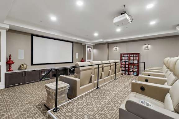 A home theater with a large screen and comfortable seating.