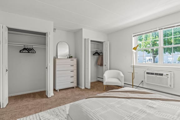a bedroom with a bed and a dresser in front of a window  at Chestnut Hill Village, Philadelphia, PA